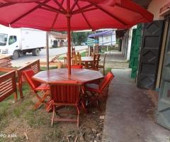 Round table with an umbrella and 4 chairs. - 2